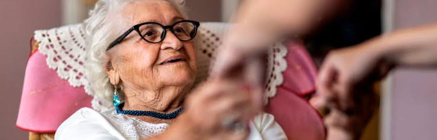Cuidadora acompanhando uma pessoa idosa com segurança